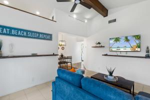 a living room with a blue couch and a table at CocoBay 2BR Condos Near Beach, Galleria Mall, Wilton Manors, Cruise Port in Fort Lauderdale