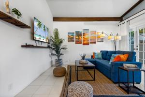 uma sala de estar com um sofá azul e uma televisão em Coco Bay Vacation Condos em Fort Lauderdale