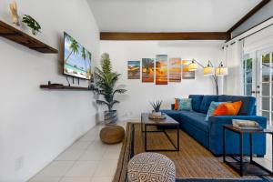 a living room with a blue couch and a tv at Coco Bay Vacation Condos in Fort Lauderdale