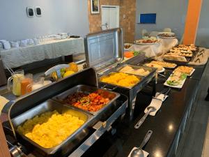a buffet line with many different types of food at HANNA Arcos d'Atalaia Hotel - Aracaju in Aracaju