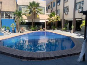a swimming pool in the middle of a building at HANNA Arcos d'Atalaia Hotel - Aracaju in Aracaju