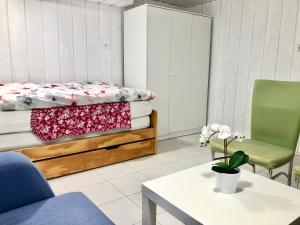 a bedroom with a bed and a table and a chair at Bambus Wohnung in Murrhardt