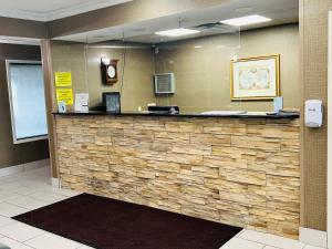 a lobby with a stone counter in a hotel room at Super 8 by Wyndham South Bend in South Bend