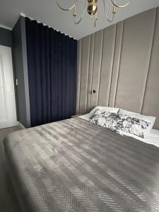 Posteľ alebo postele v izbe v ubytovaní Apartament Złote Noce