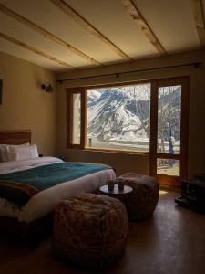 a bedroom with a bed and a large window at La Hault in Sissu