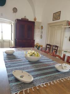 a table with three bowls on top of it at Masseria Vivi il Salento in Santa Caterina di Nardò