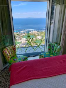 a bedroom with a large window with a view of the ocean at Casa Marta Capri in Capri