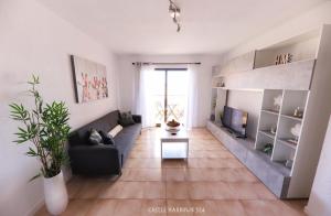 a living room with a couch and a tv at CH 524 Sea View in Los Cristianos