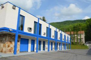 a blue and white building with blue windows at Economy Inn Bluefield in Bluefield