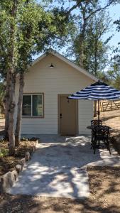 uma casa com uma mesa de piquenique e um guarda-chuva em Clingan's Junction Cottage #4 em Squaw Valley