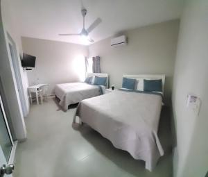 Apartahotel MACADANA客房内的一张或多张床位