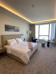 pokój hotelowy z łóżkiem i dużym oknem w obiekcie Palm Tower Palm Jumeirah Dubai w Dubaju