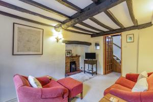 a living room with two chairs and a fireplace at Appledene in Tewkesbury