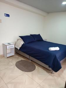 A bed or beds in a room at Hospedaje Room's El Dorado