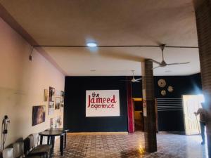 a dining room with a sign on the wall at Safi Kitchen Hostel in Aş Şāfī