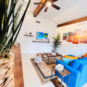 a living room with a blue couch and a table at Coco Bay Vacation Condos in Fort Lauderdale