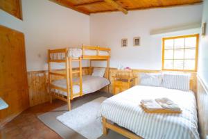 a bedroom with two bunk beds and a ladder at Bungalow Cajamarca, con Wifi y Cochera in Cajamarca