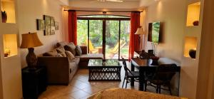 a living room with a couch and a table at The Oaks Tamarindo Primer piso, 22, 49, 73 in Tamarindo
