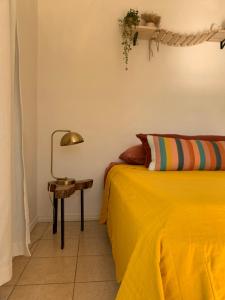 a bedroom with a bed and a side table at Casa Buda Liberia Cerca del Aeropuerto in Liberia