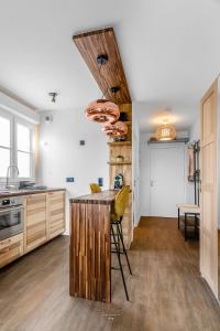 Una cocina con gabinetes de madera y una mesa con sillas. en *DISNEYLAND-SERRIS* Studio Cosy, en Serris 5 fotos más