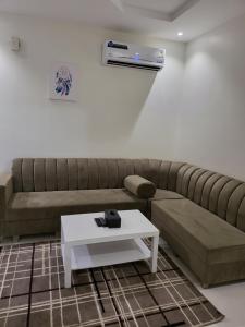 a living room with a couch and a table at Al Mabeet 2 Hotel suites in Abha