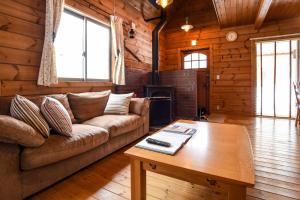 a living room with a couch and a coffee table at Betsu Inn in Hakuba