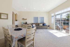 a living room with a table and a couch at Santo Tomas Getaway in Grover Beach