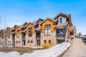 a large house in the snow on a street at Urban Mountain Getaway & Alpenglow Chalet in Steamboat Springs