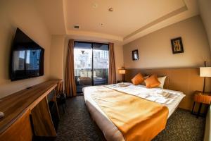 a hotel room with a bed and a television at Hotel S-Presso South in Osaka +35 photos