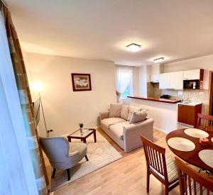 a living room with a couch and a table at Chance Apartman-Birdland Villapark Bükfürdő in Bük