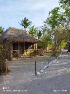 a small hut with a thatched roof and a road at Room in BB - Mida Creek Eco Camp 1 
