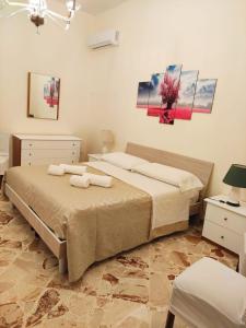 a bedroom with a bed with two towels on it at Casa Mia, vacanze in Marsala