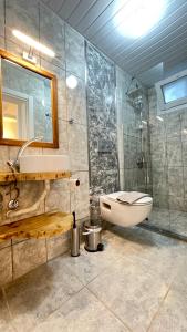 a bathroom with a shower and a sink and a toilet at Kaktus Beach Apart in Kas +75 photos