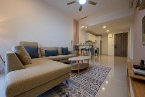 a living room with a couch and a table at Greystone Continew Residensi in Kuala Lumpur