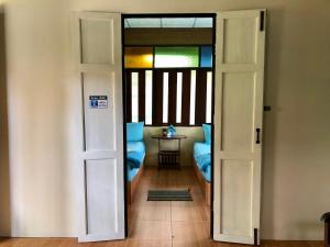 an open door to a room with a table in a room at Pop riverside trat in Trat