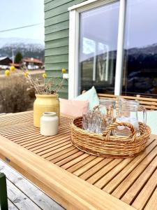 a picnic table with a basket and glasses on a porch at Stort og autentisk hus i Skjåk - kort vei til Lom! in Skjåk