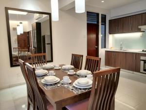 a dining room table with chairs and plates on it at City Tropical Home I in George Town