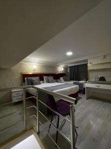 a large room with two beds and chairs in it at RHYTHM HOTEL in Istanbul