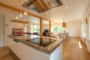 an open kitchen and living room with a large island at Yuzuki in Kutchan +18 photos