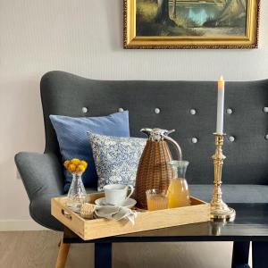 a table with a candle on top of a chair at Rønhave in Sønderborg