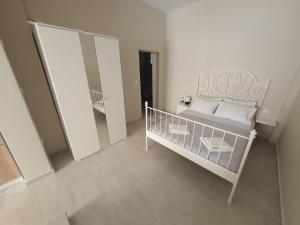 a small bedroom with a bed and a mirror at New apartment ,50m from the sea at Nea Irakleia. in Nea Irakleia
