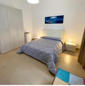 A bed or beds in a room at Porto Gaio Accomodation