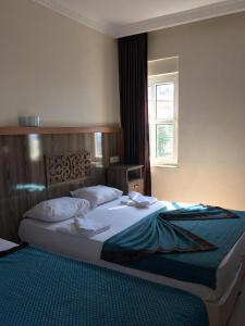 a bedroom with a large bed with a window at Sky Alremu Apart Hotel in Side