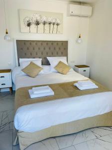 a bedroom with a large bed with towels on it at A CASA DI JO in Calenzana