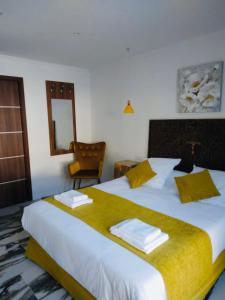 a bedroom with a large bed with towels on it at A CASA DI JO in Calenzana