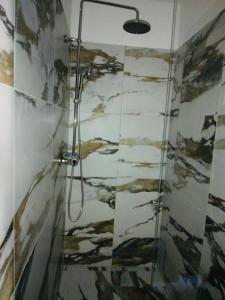 a bathroom with a shower with a painting on the wall at A CASA DI JO in Calenzana
