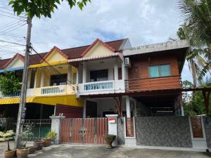a wooden house with a fence in front of it at Pani House Hatyai 1 in Hat Yai
