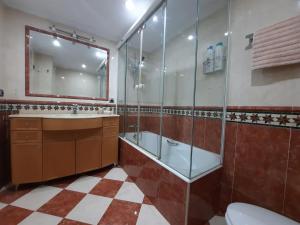 a bathroom with a sink and a shower and a toilet at Feria apartment, near Plaza España in Seville +21 photos