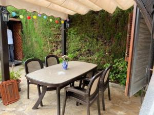 a table and chairs under an umbrella on a patio at Casa Blanca 42 – Piscina, BBQ y Wifi (5 pax) in Tossa de Mar