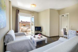 a living room with two couches and a table at Aldebaran Hotel Apartments in Limenaria
